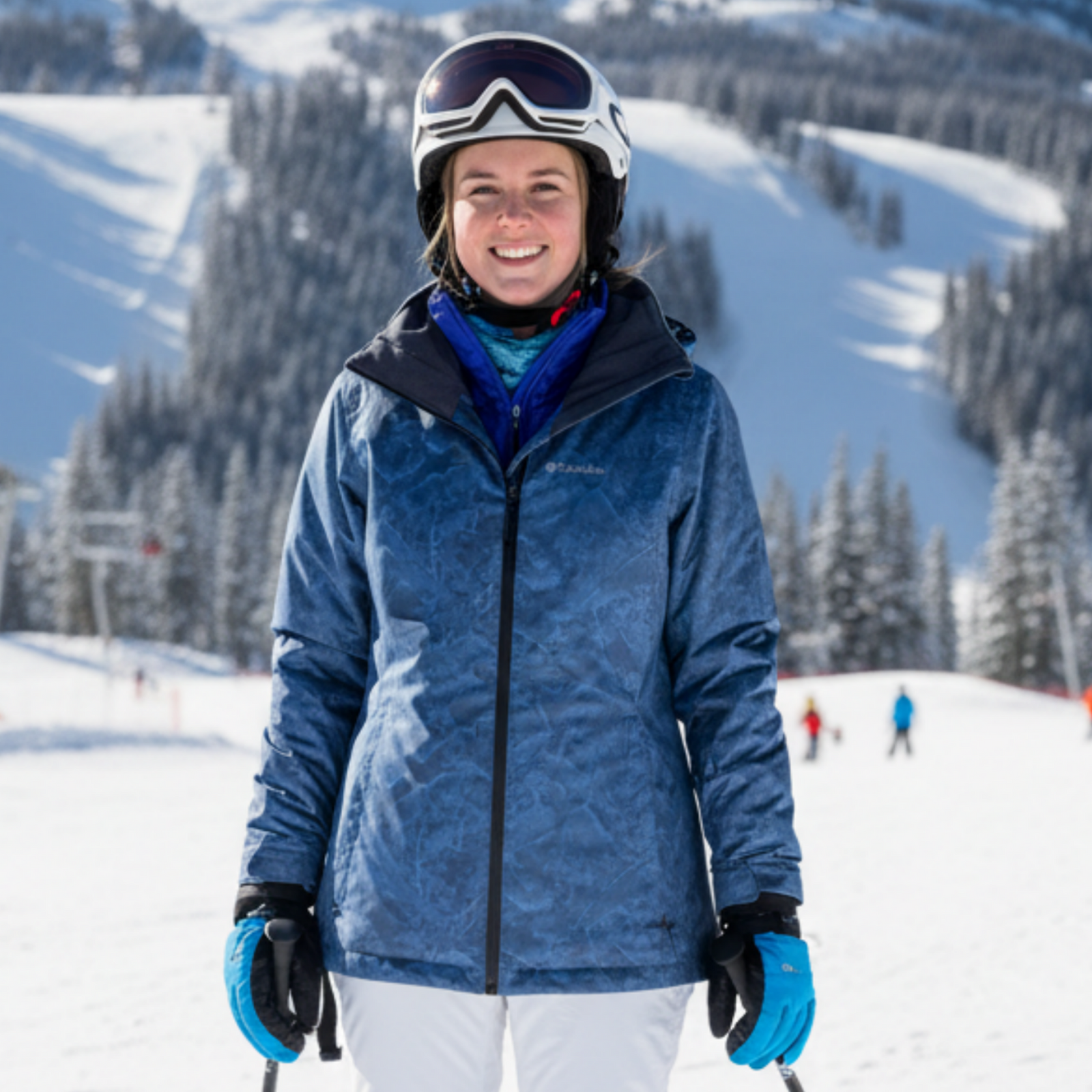 Columbia Omni-Tech Women's Whirlibird 3 Interchange 3-in-1 Insulated Ski Jackets In a Blue Pattern on a female model posing on a ski hill | ScoutTech Outfitters