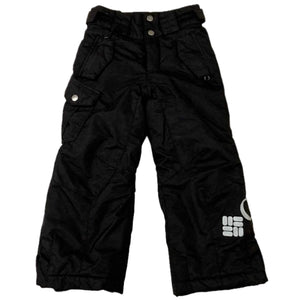 Columbia Boy's Bugaboo Waterproof Insulated Snow Pants in black lying flat on a white background.  View of the front side. A large Columbia label written across the left leg.  Two front pockets with zippers and flaps are shown.  A cargo pocket on the right leg and front fly are secured by 2 silver snaps.  There is also an adjustable waist band with hook and loop closures and belt loops. | ScoutTech Outfitters Mississauga Store