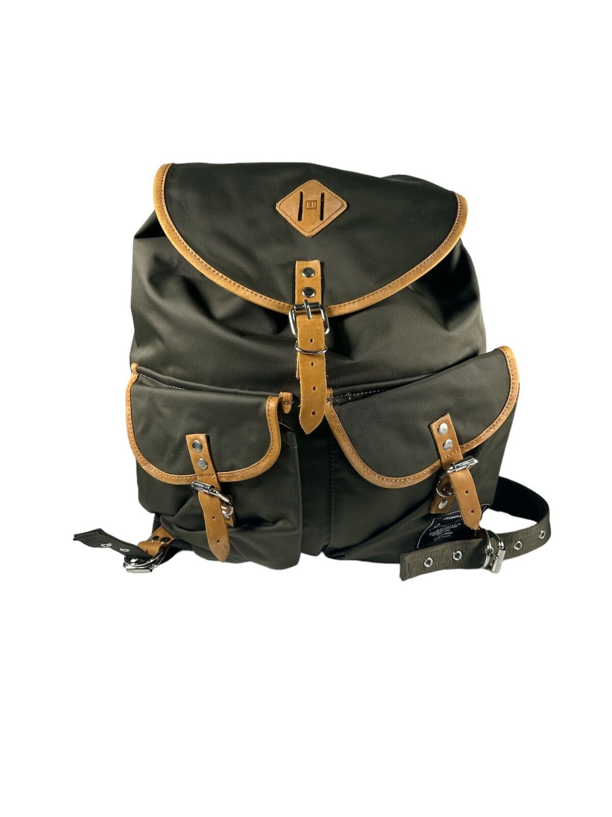 A green retro-style backpack with brown leather accents and a visible brand logo, featuring multiple compartments and straps.