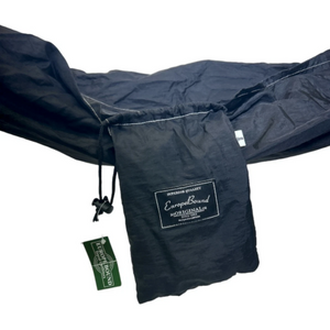 A black Europe Bound Parachute Hammock Single Adult Size camping hammock suspended horizontally, showing its interior lining and a small black hanging pouch with a visible logo, isolated on a white background. | ScoutTech Outfitters Mississauga Store