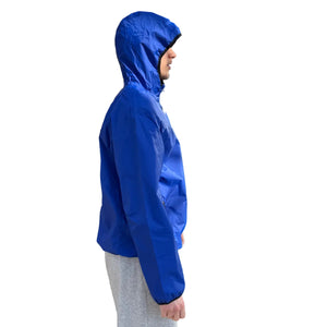 Europe Bound Unisex Waterproof Breathable Raincoats with Stash Pocket in Blue Displayed on Model with Hood Up Side View | ScoutTech Outfitters