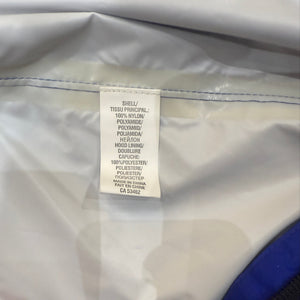 Europe Bound Unisex Waterproof Breathable Raincoats with Stash Pocket in Blue Materials Tag Close-Up | ScoutTech Outfitters Mississauga Store