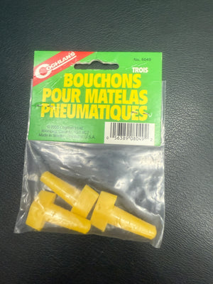 Yellow plastic plugs in a clear package with green label on a dark background