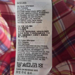 Marmot Women's Cassidy Button Up Short Sleeve Shirt in Red Plaid Close up of tags showing materials composition and care instructions | ScoutTech Outfitters Mississauga Store