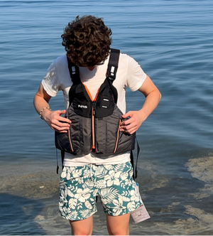 NRS Men's Oso PFD's Front Zip Life Jackets UL and ULC Approved in Grey with Orange Accents On Model Standing on Beach | ScoutTech Outfitters Mississauga Store