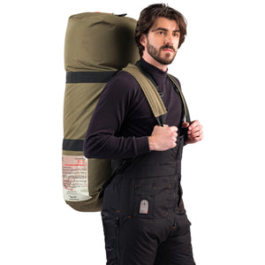 Outdoor Survival Canada Igloo -60C Multi-Season Down Sleeping Bag in Green Transport Duffle with Backpack Straps worn by a male model | ScoutTech Outfitters Mississauga