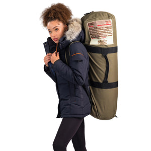 Outdoor Survival Canada Igloo -60C  Sleeping Bag in Green Transport Duffle with Backpack Straps worn by a female model Side View with OSC Patch | ScoutTech Outfitters Mississauga