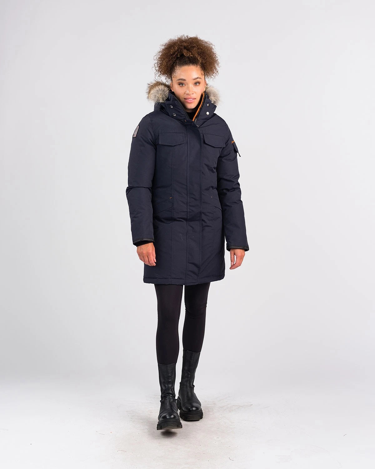 Female wearing a dark blue osc winter coat with fur-lined hood on a white background | ScoutTech Mississauga Store