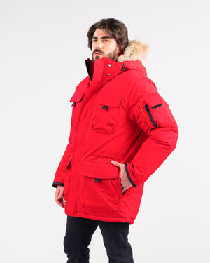 Outdoor Survival Canada OSC Men's Atka -40 Down Parka in Red Alert on Model with Left Hand in Pocket View | ScoutTech Outfitters