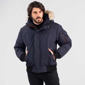 Outdoor Survival Canada OSC Men's Desna -40 Down Bomber Jackets on Model Using Hand Warmer Pockets in Cold Lake Blue Colour | ScoutTech Outfitters Mississauga