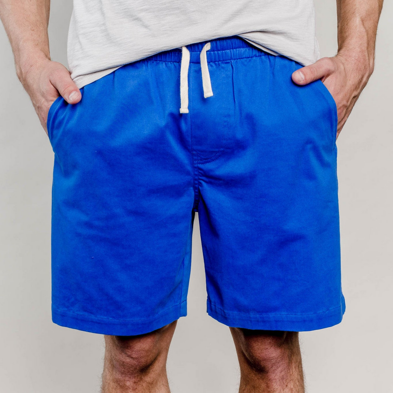 United By Blue Mens Spence Cotton Stretch Athletic Shorts in Blue on a model on a white back ground | ScoutTech Outfitters