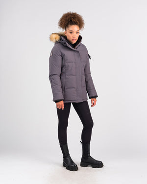 Outdoor Survival Canada OSC Women's Nukka -40 Down Parka in Charcoal Grey on Model Right Side View with Brand Patch | ScoutTech Mississauga Store