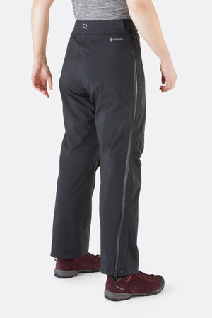 Rab Women's Kangri GTX Rain Pants in Black with Full Zipper Rear and Right Leg View with RAB and Gore-Tex Logos | ScoutTech Outfitters 