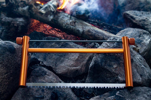 Rockwater Designs Ultralight Collapsible Buck Saw in Orange on a rocky background | ScoutTech Outfitters Mississauga Store 